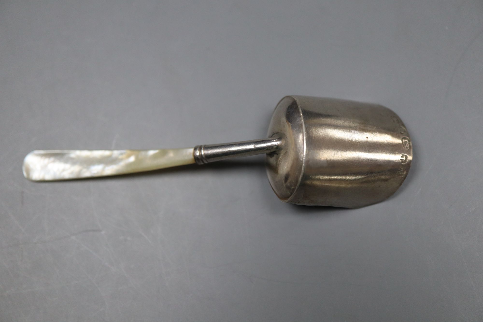 A George III mother of pearl handled silver caddy spoon, Joseph Taylor, Birmingham, 1817, 99mm.